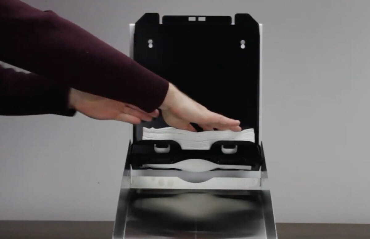 Person refilling paper towel dispenser